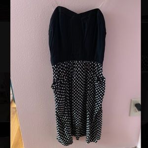 Strapless corset-top dress, flowing skirt detail.